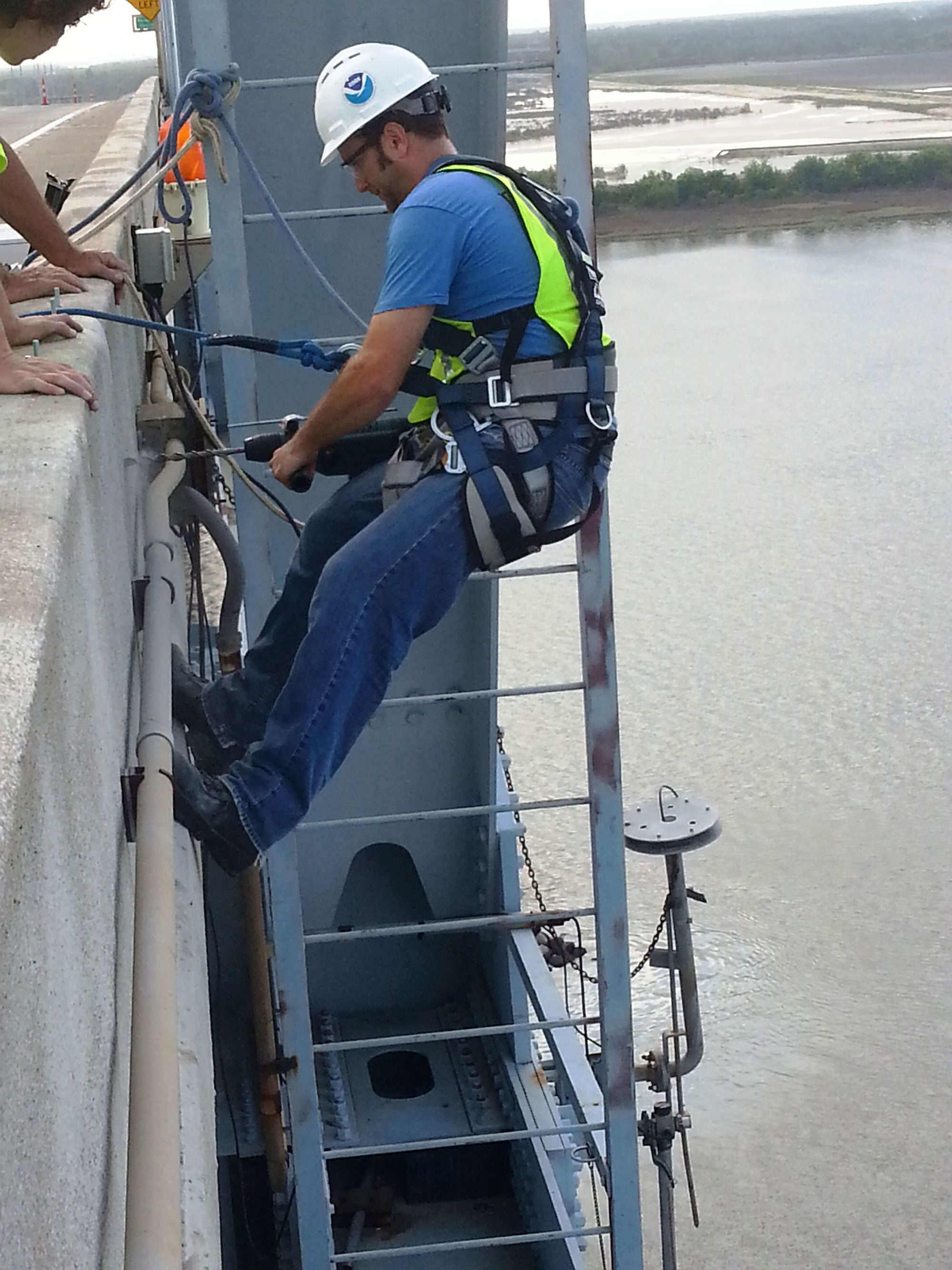  Center for Operational Oceanographic Products and Services staff installs an air gap sensor on the Don Holt Bridge in Charleston, South Carolina. The sensor is part of the Charleston Harbor Physical Oceanographic Real-Time System, or PORTS®. Information from the sensor is critical for under bridge clearance, as ships continue to maximize channel depths and widths while, at the same time, push the bounds of bridge heights.